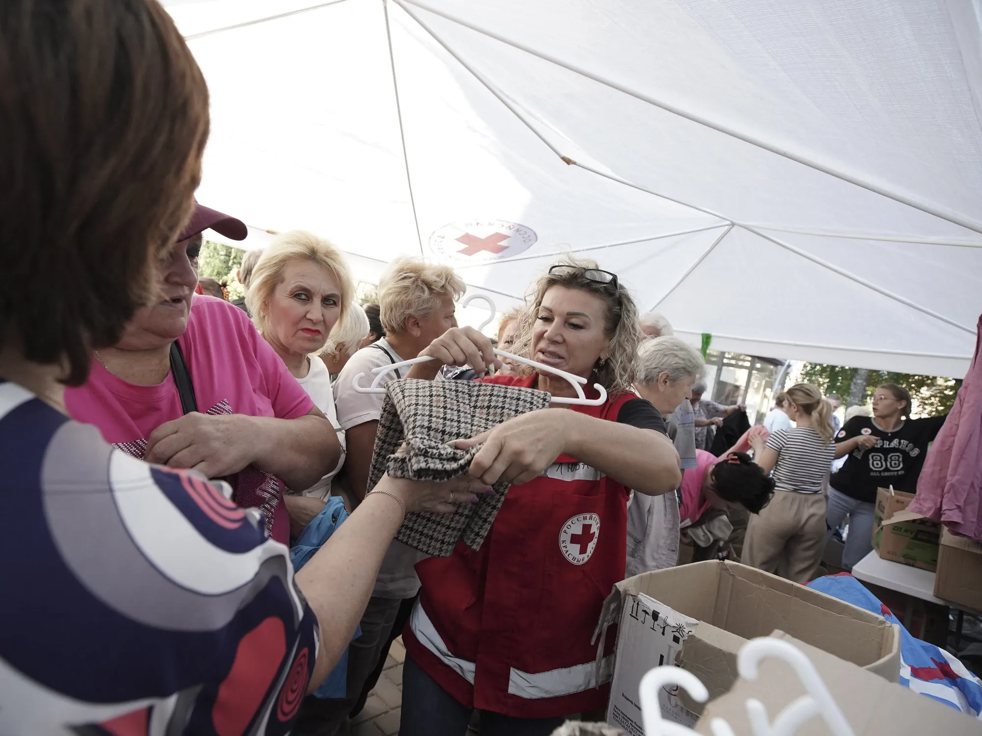 Russian civilians displaced by Ukraine’s offensive collecting aid.