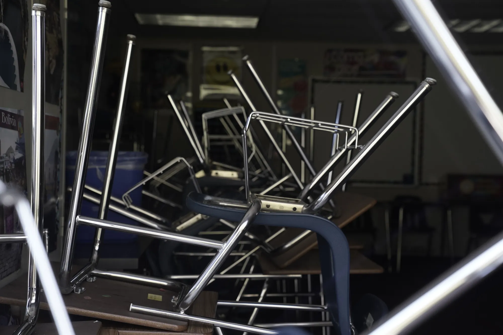 Stacked desks and chairs sit inside an empty classroom at a high school in San Diego, California.