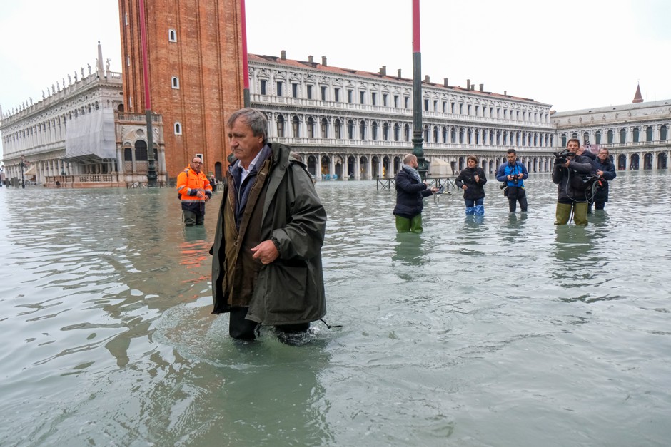 Venice Mayor Luigi Brugnaro walks on St. Mark's Square as exceptionally high tidal flooding engulfs the city.