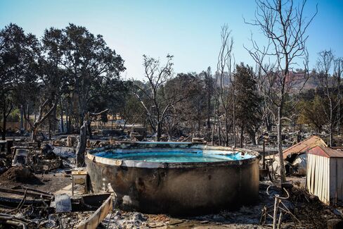 Burned residences, vehicles and a pool line a fire-ravaged neighborhood in Lower Lake, California, on August 16.