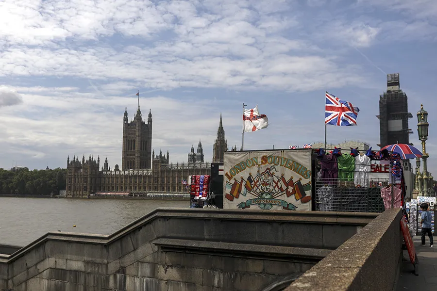 A tourist souvenir stall sits in view of the Houses of Parliament in London.