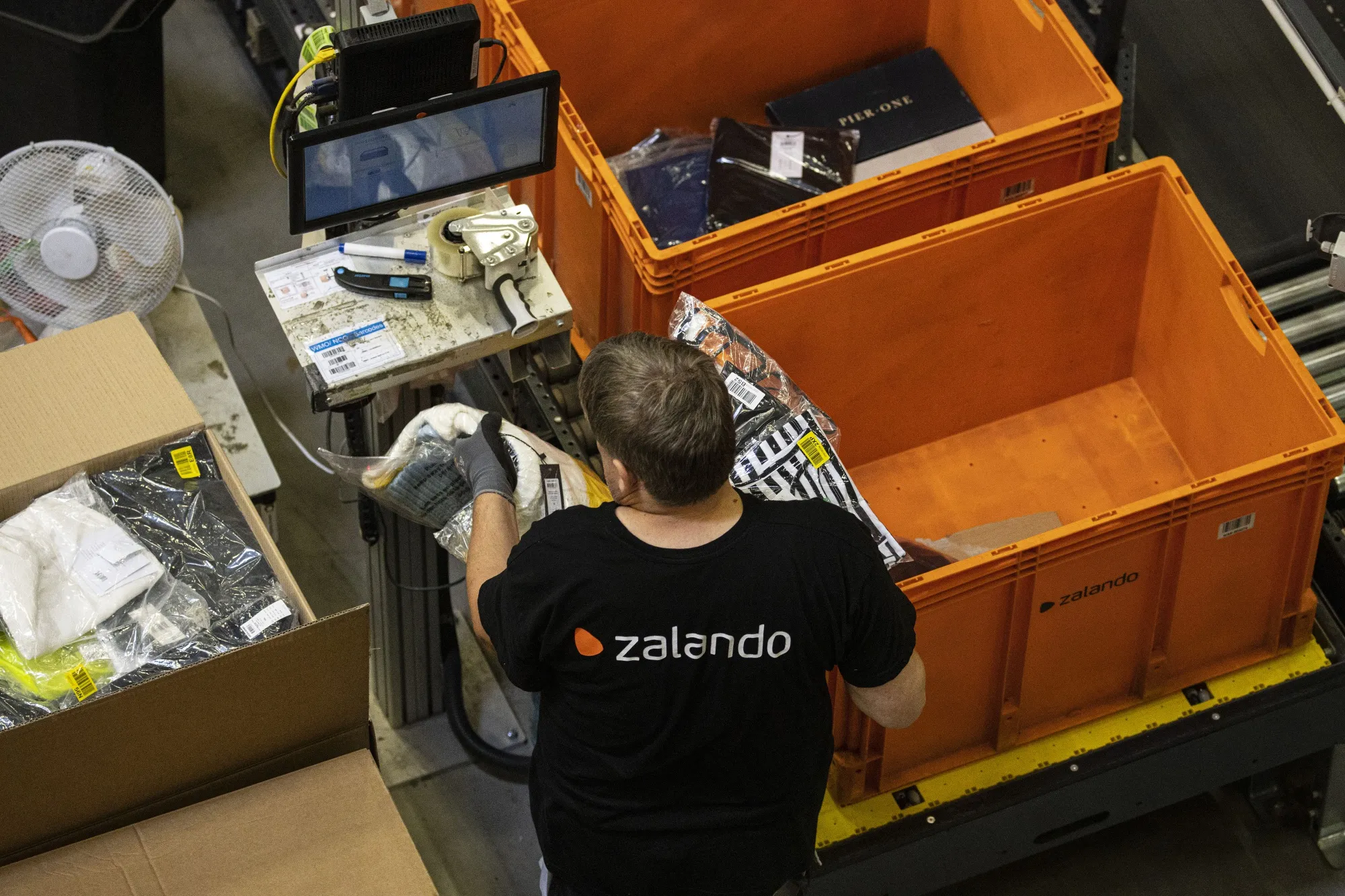 Garments sealed in plastic bags are packed for orders inside the Zalando SE fulfillment center in Erfurt, Germany.