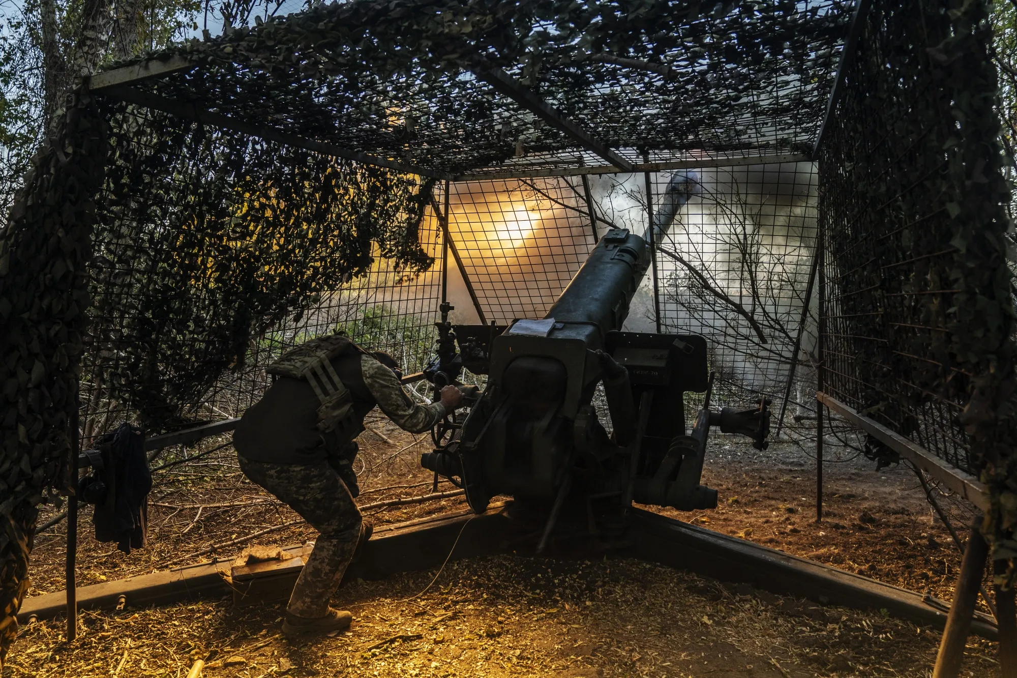 Ukrainian soldiers fire artillery in the direction of the Borova front, Ukraine on Oct. 4.