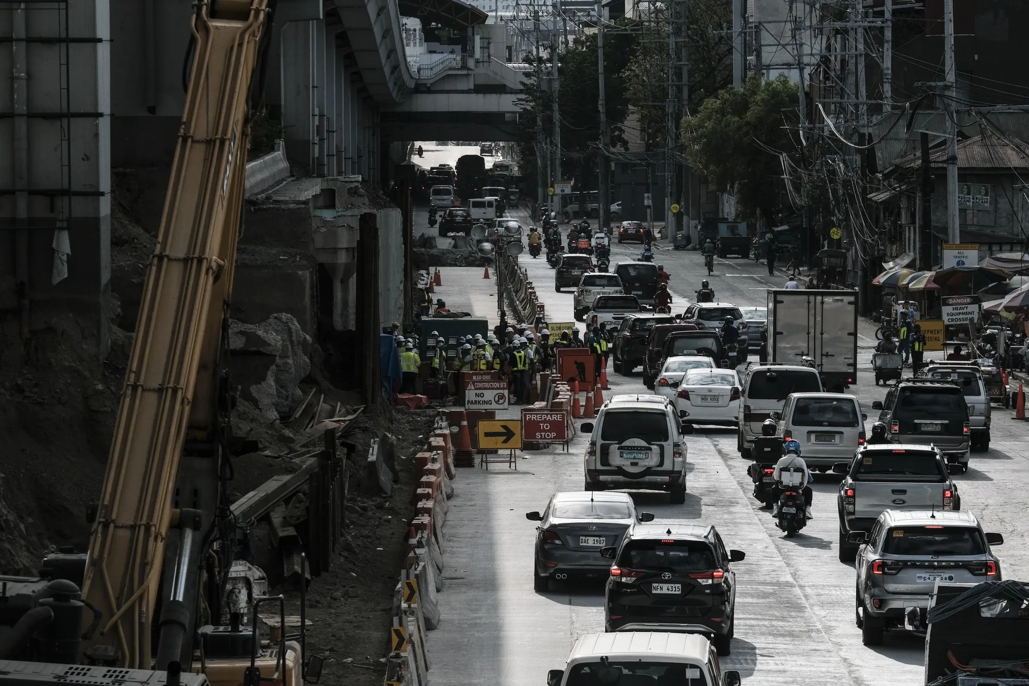 Vehicles drive past a construction site in Manila, the Philippines.