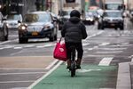 A bike messenger carries a DoorDash Inc. bag during a delivery in New York, U.S., on Wednesday, Dec. 9, 2020. 