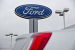 The Ford Motor Co. logo stands at the Sutton Ford Lincoln car dealership in Matteson, Illinois, U.S..
