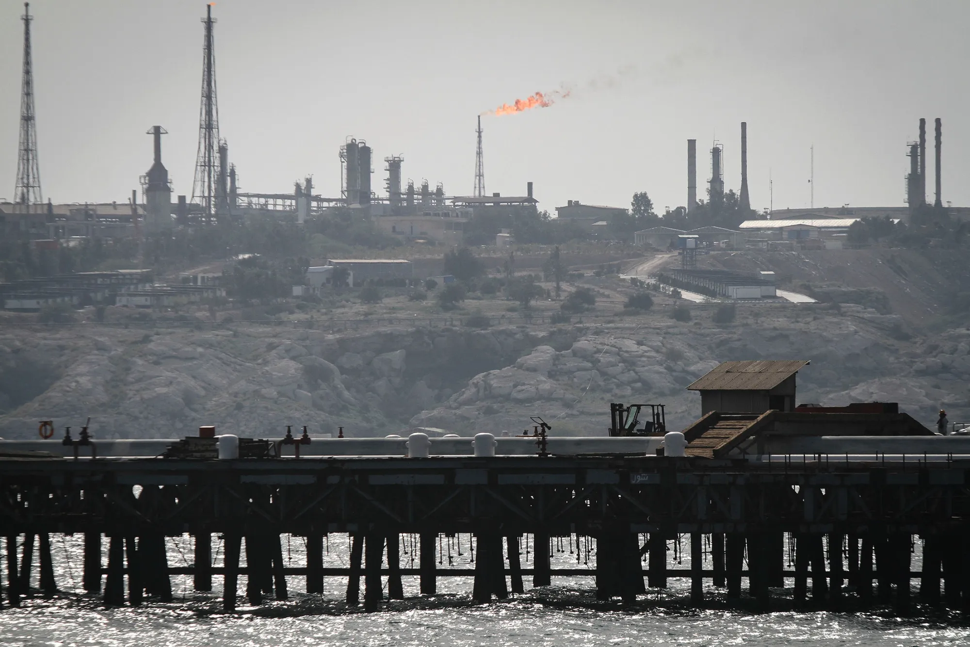 A picture shows an oil facility in the Khark Island, on the shore of the Gulf, on February 23, 2016. Iran's Oil Minister Bijan Namdar Zanganeh dismissed an output freeze deal between the world's top two producers Saudi Arabia and Russia as 'a joke', the ISNA news agency reported. / AFP / STR (Photo credit should read STR/AFP/Getty Images)
