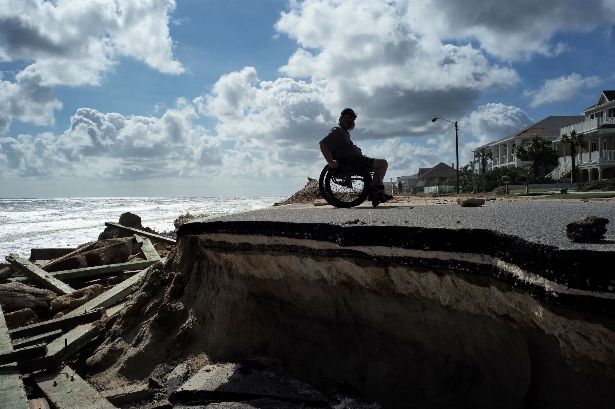 A wheelchair user negotiates a washed-out highway in Flagler Beach, Florida, in the wake of Hurricane Matthew, in 2016.&nbsp;