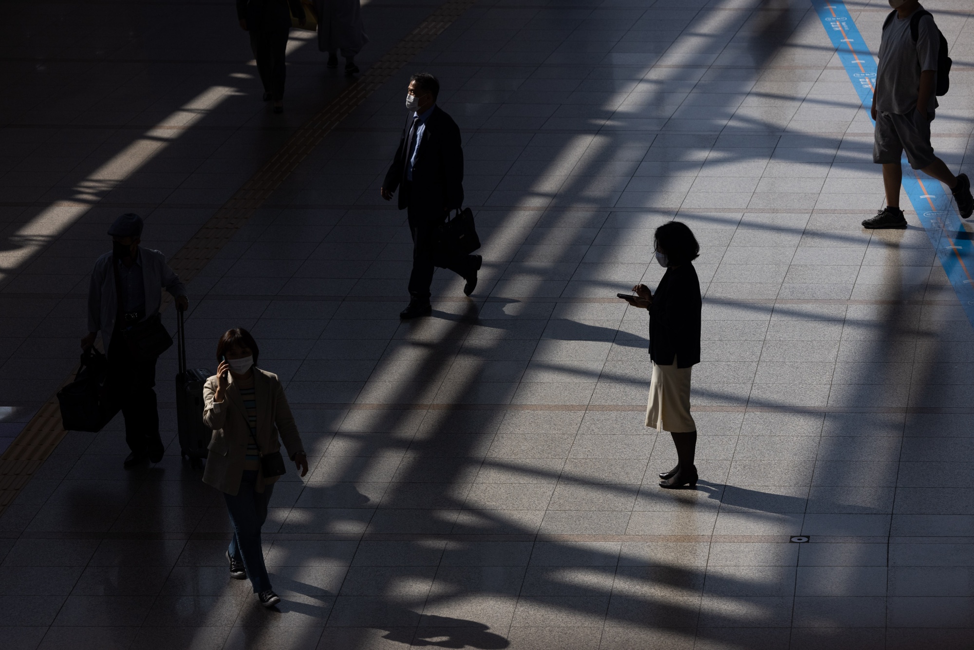 A pedestrian uses&nbsp;a smartphone at...</p>
</div>
<div class=