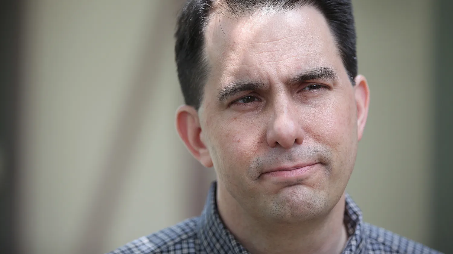 Governor Scott Walker of Wisconsin speaks to reporters outside Dallas County Recorder Chad Airhart's annual Blue Jean Bash on May 16, 2015 in West Des Moines, Iowa.
