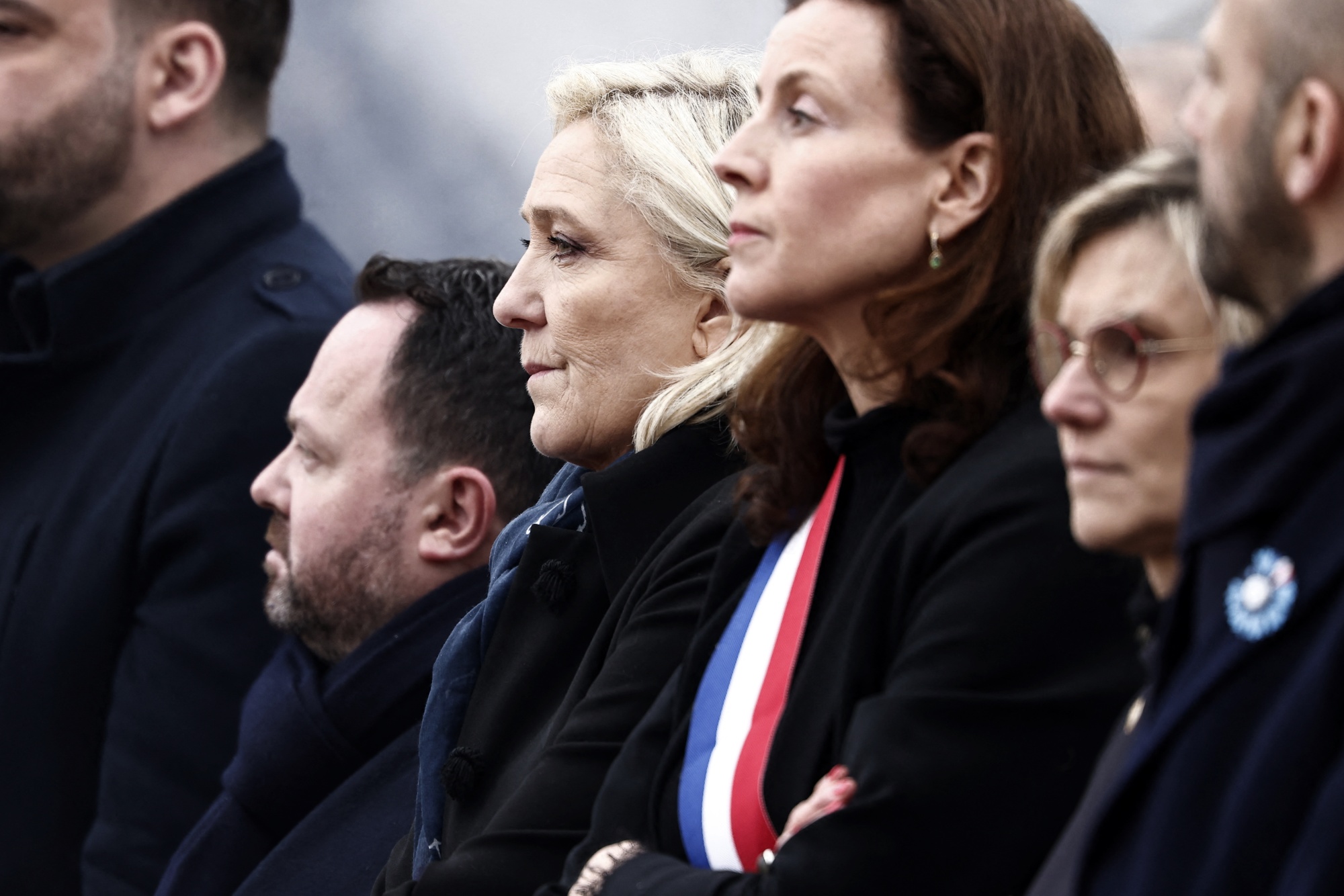 Marine Le Pen, center, attends a ceremony in northern France&nbsp;on Monday.