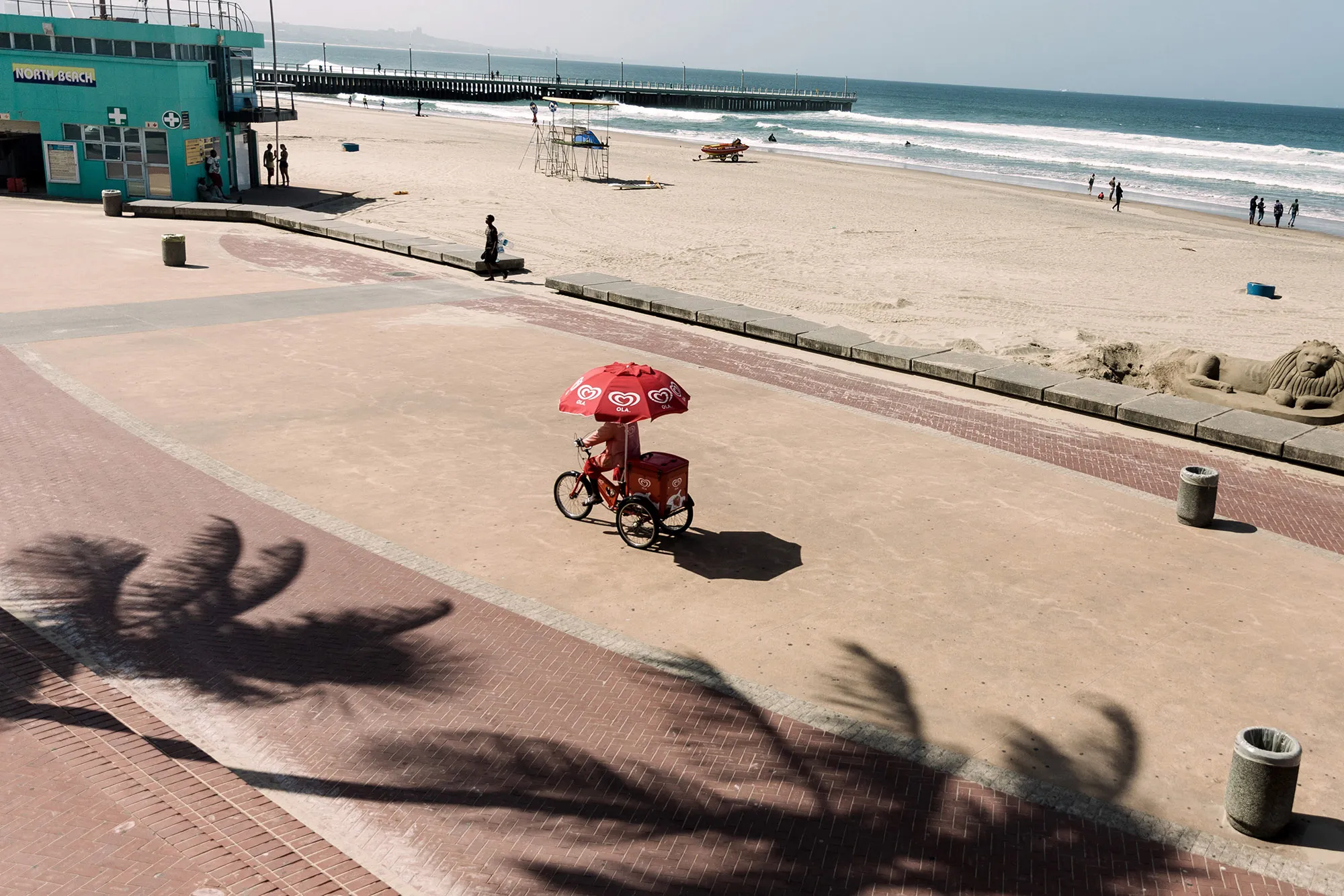 An ice cream vendor on a tricylce at the deserted north beach in Durban during measures imposed to combat the coronavirus.