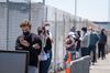 People wearing protective masks wait in line to get a Covid-19 swab test at a testing site in San Francisco, California, U.S., on Thursday, July 30, 2020. California recorded 194 new virus deaths, second only to the 197 reported Wednesday and above the 14-day average of 112.