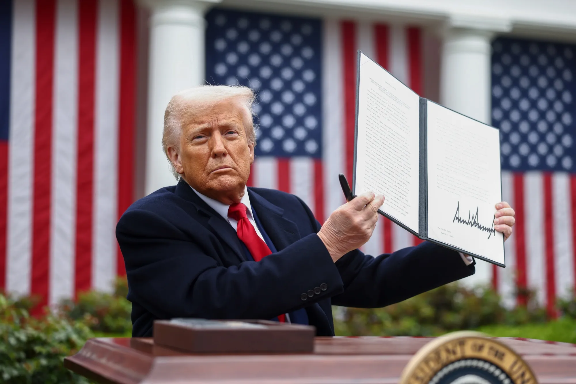 Donald Trump displays a signed executive order during a tariff announcement in the Rose Garden of the White House in Washington, DC, on&nbsp;April 2, 2025.&nbsp;
