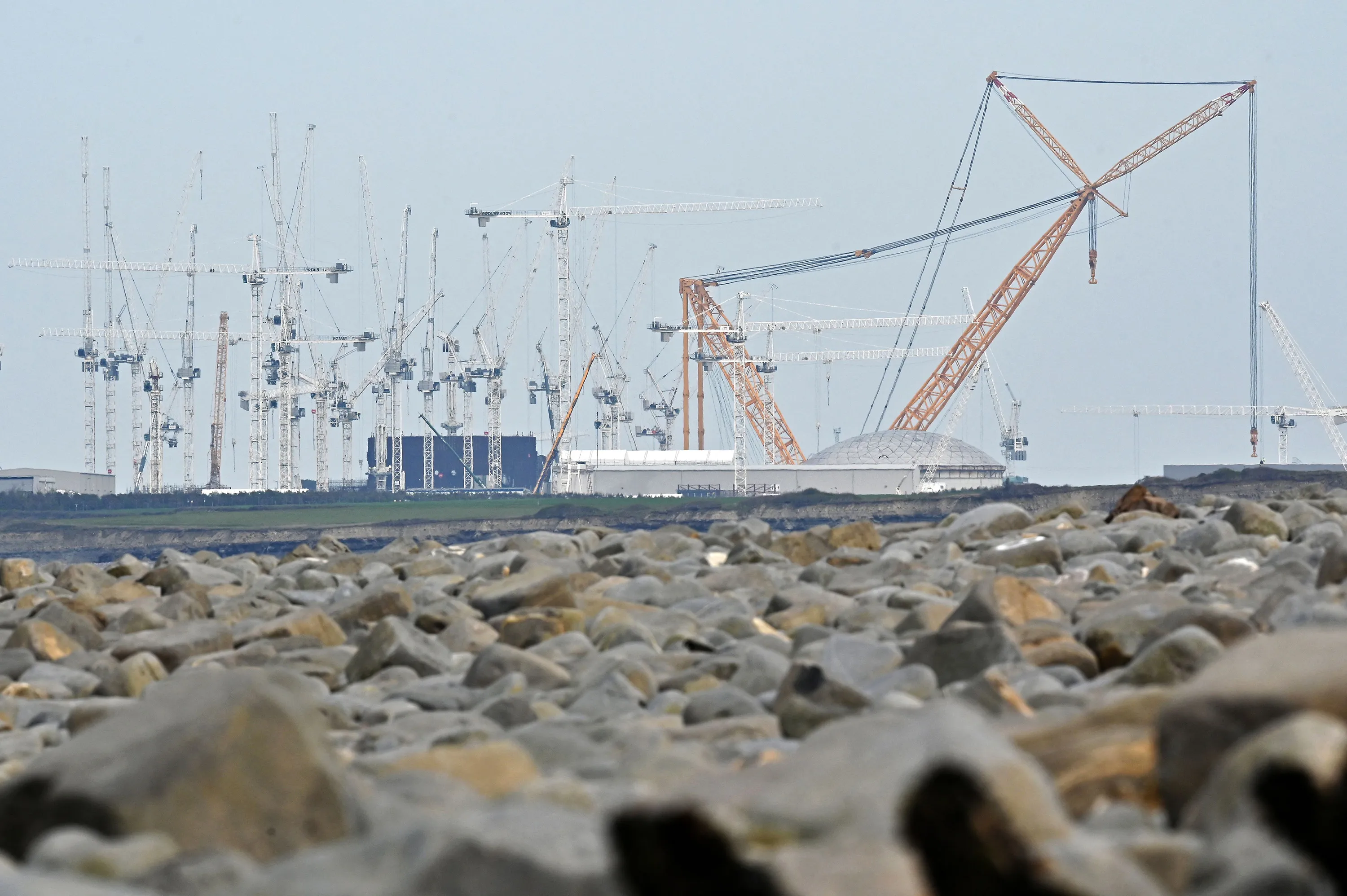 Cranes on the horizon at the site of Hinkley Point C nuclear power station under construction near Bridgewater, U.K.