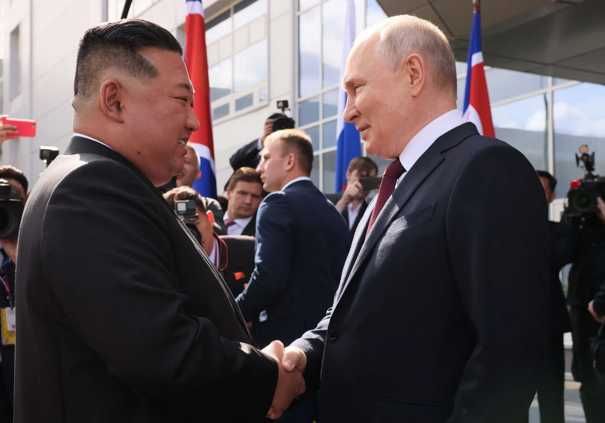 Vladimir Putin&nbsp;shakes hands with Kim Jong Un as they both arrive at the Vostochny Cosmodrome in Russia's far east.