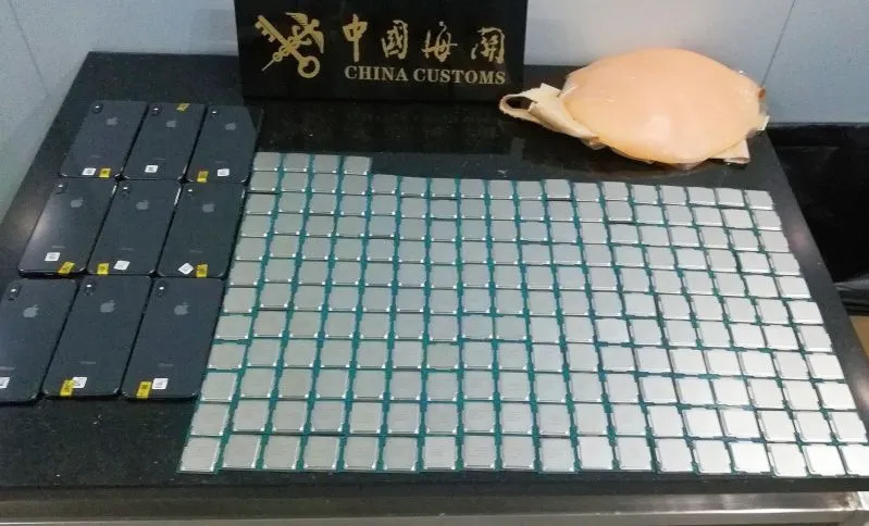 The semiconductors, smartphones and fake baby bump that customs officials in Zhuhai, China, seized on Nov. 25.
