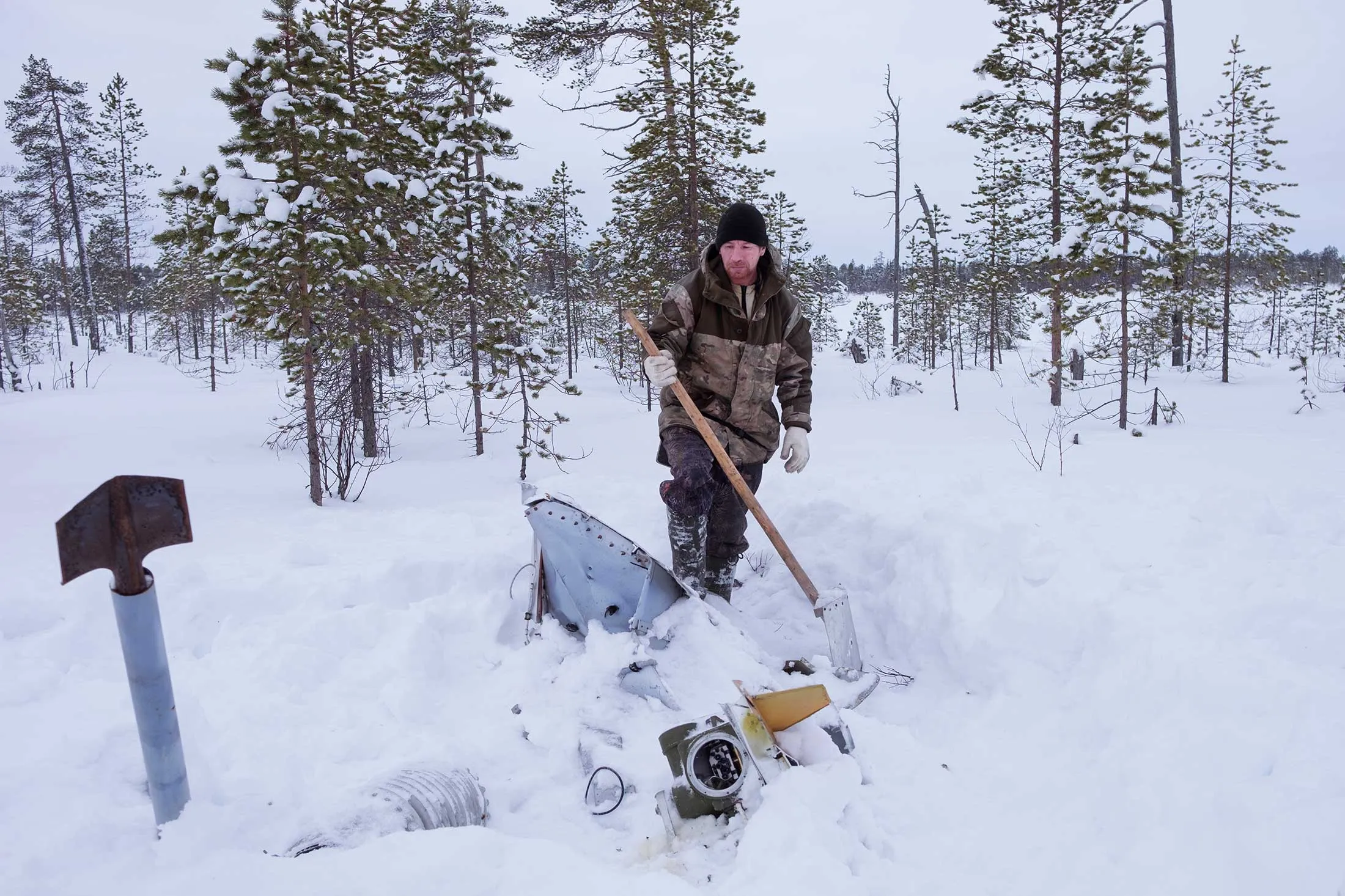Pavel, 46, uses a hoe made from a rocket part to dig out some debris a few hours north of Dolgoshchelye, one of about 10 communities where residents scavenge for space junk.