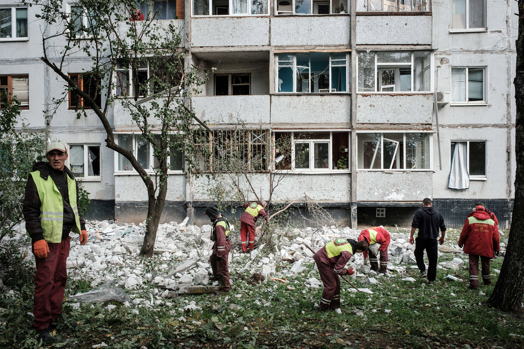 Municipal workers remove the debris from the top of a residential building hit by a missile attack in Kharkiv, on Sept.&nbsp;21.&nbsp;