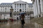 A pedestrian walks past the Bank of England in the City of London, U.K.