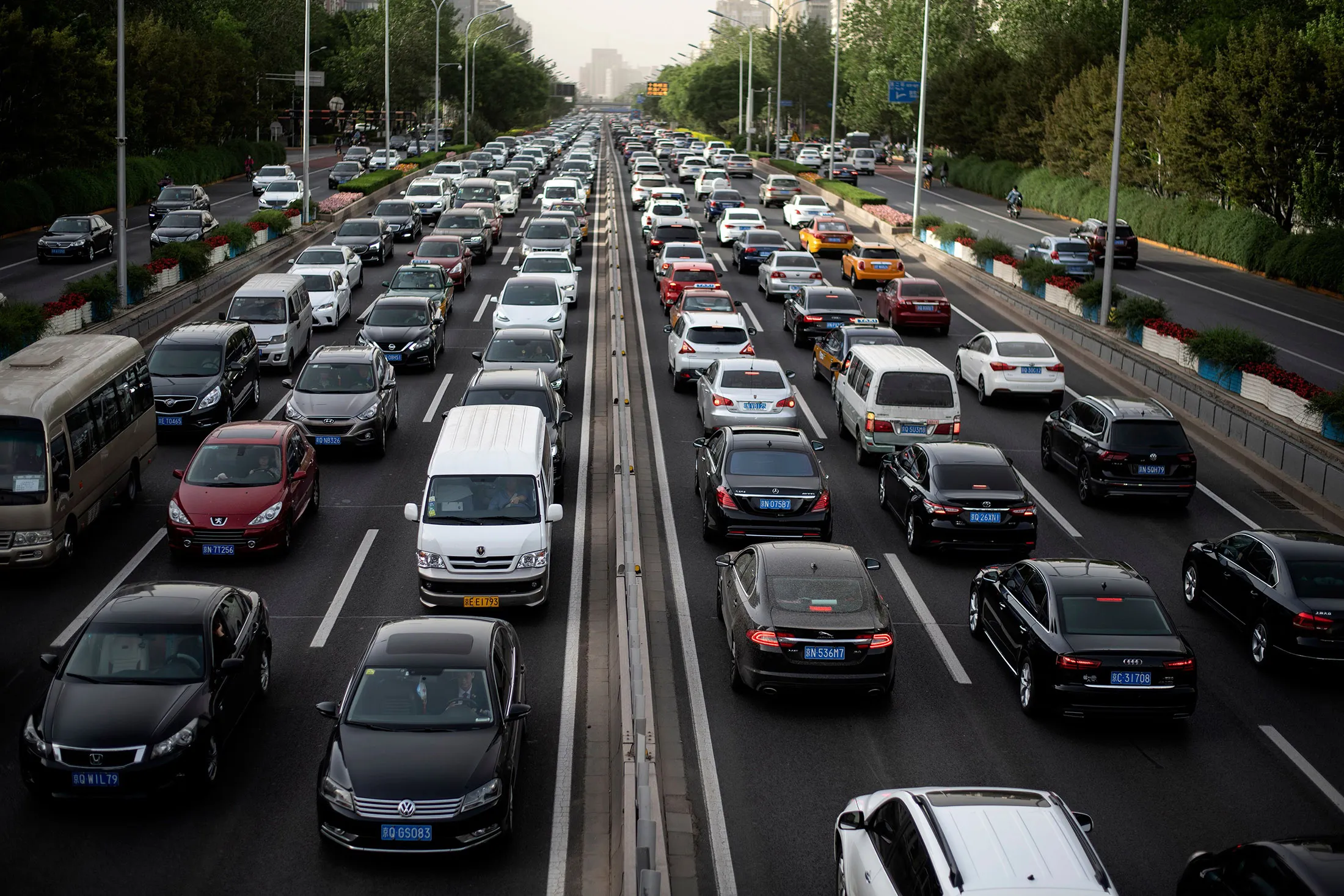Commuters make their way along a busy road in Beijing on May 12.