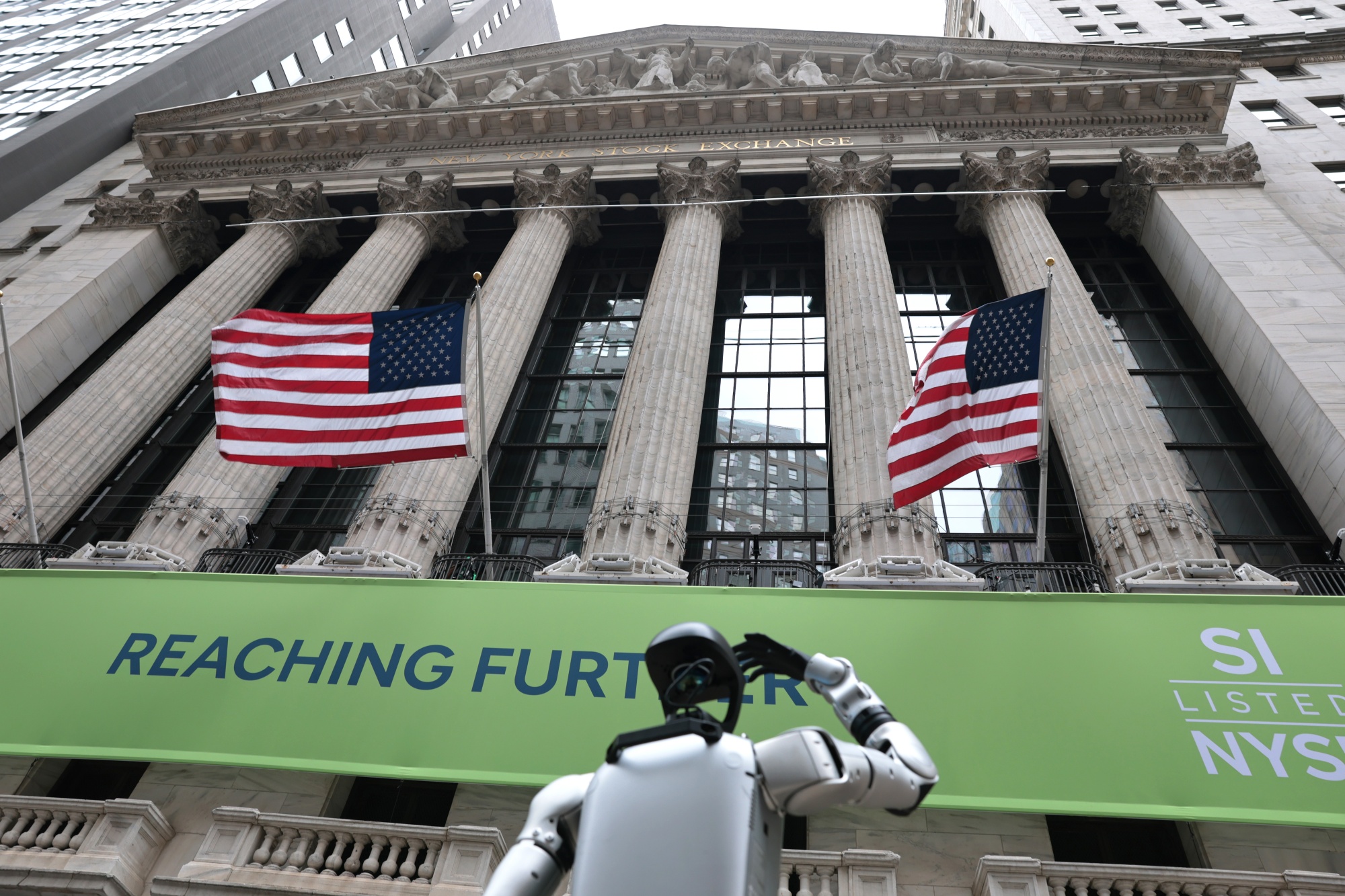 NEW YORK, NEW YORK - AUGUST 01: A Robostore Advanced Humanoid Robot is demoed for passersby in front of The New York Stock Exchange during afternoon trading on August 01, 2025 in New York City. All three major stock indexes tumbled with the Dow Jones leading the way losing over 400 points amid signs of a weakening economy and U.S. President Donald Trump’s modified tariff rates. (Photo by Michael M. Santiago/Getty Images)