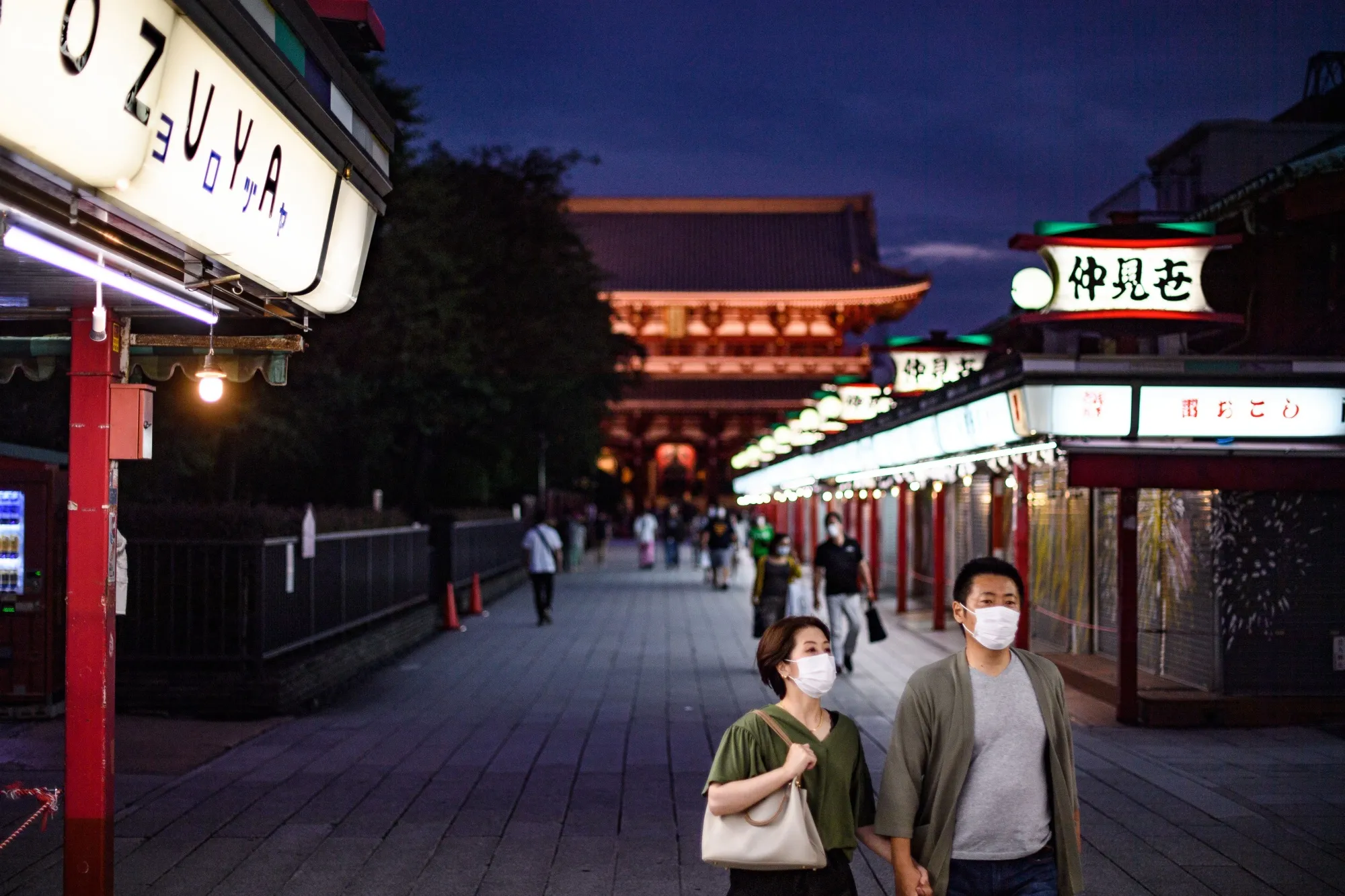 A couple in face masks walk at Sensoji Temple in Tokyo on June 28.