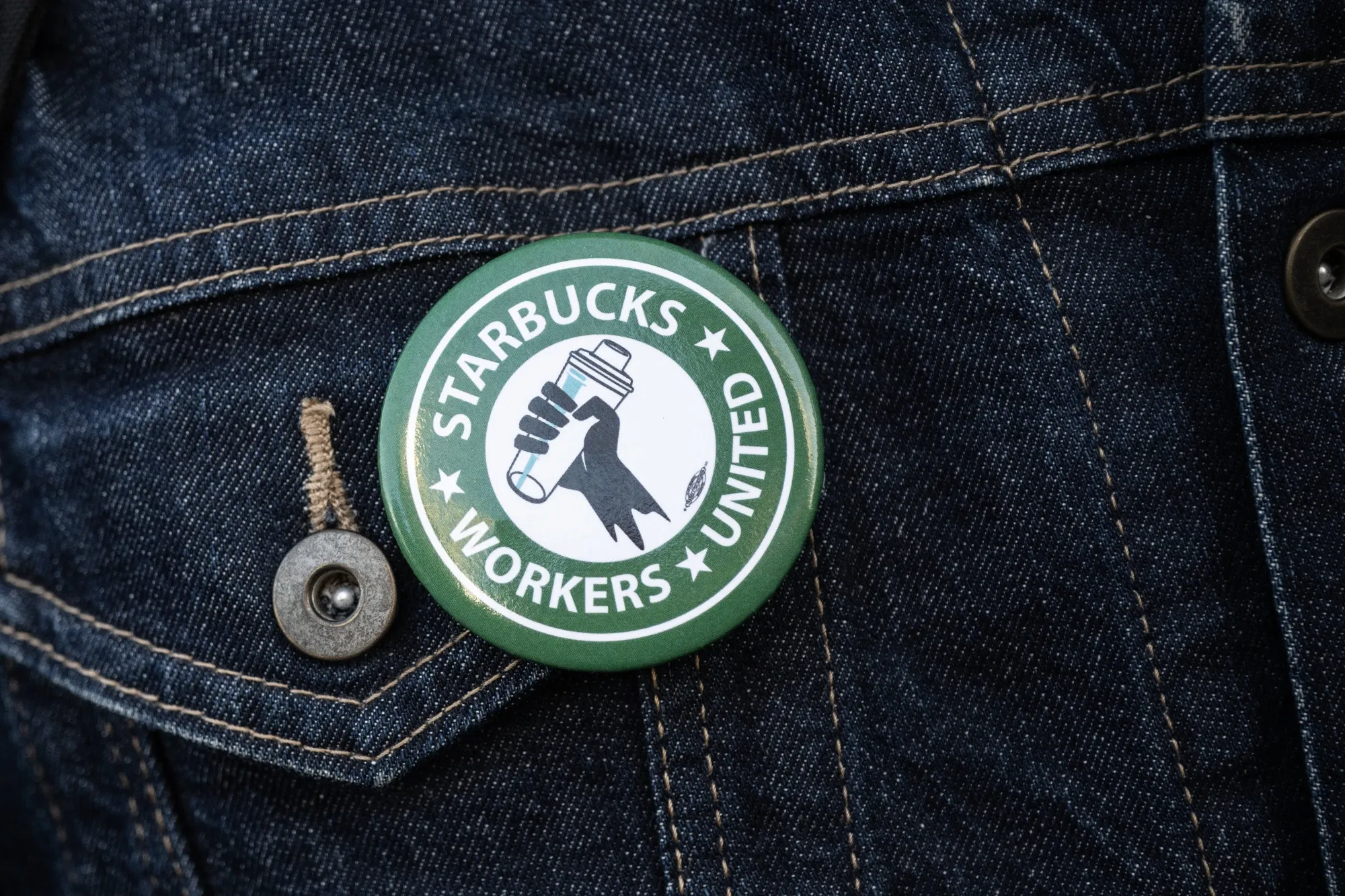 An organizer wearing a Starbucks Workers United button in 2023.