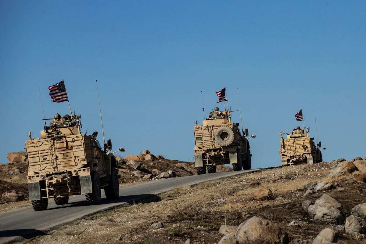 A convoy of U.S. armored vehicles patrol near the village of Ein Diwar, in Syria, on Nov. 4.