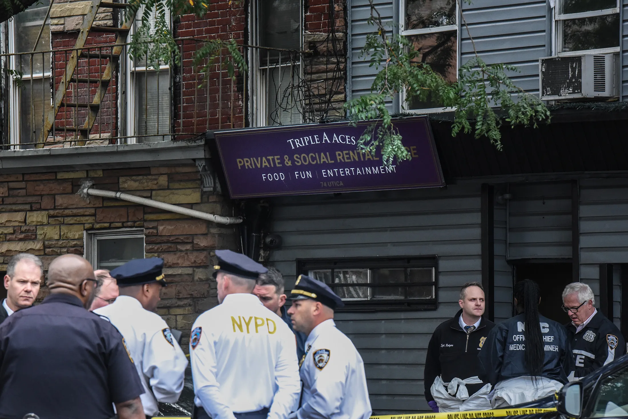Police gather in front of the Triple A Aces social club on Utica Avenue on Oct.&nbsp;12.