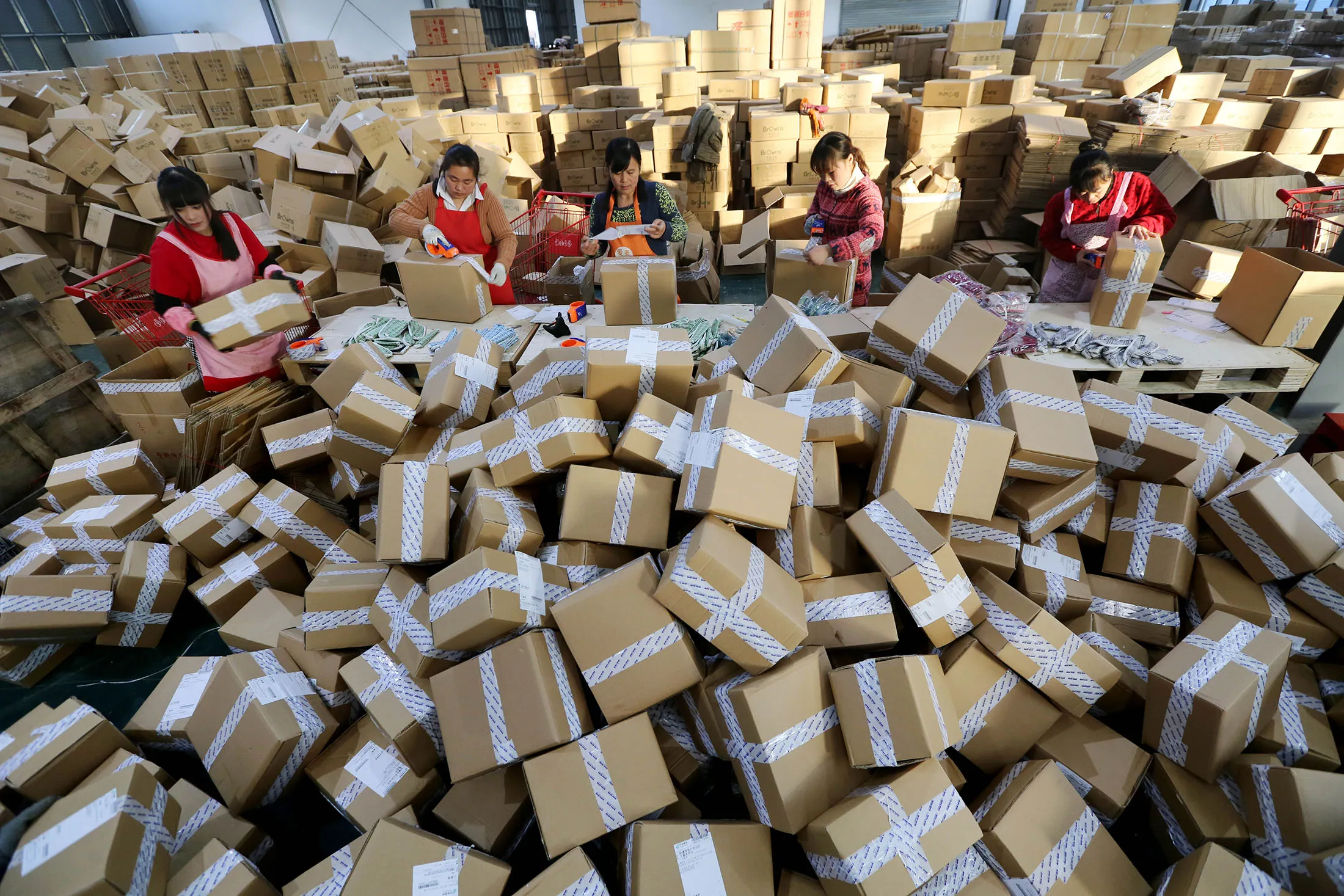 &nbsp;Workers distribute express parcels at a logistics centre of China Post