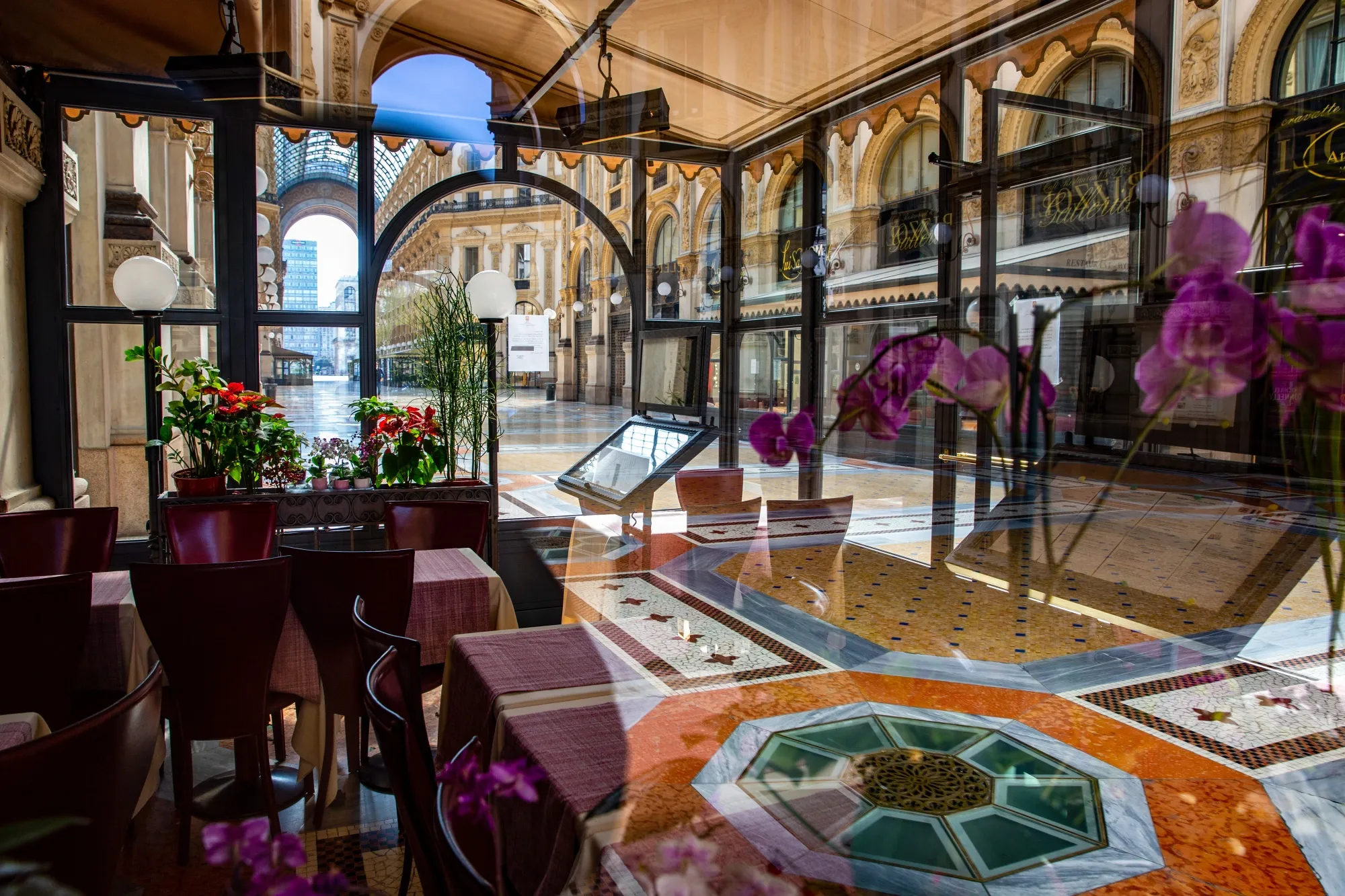 Tables sit empty in a closed restaurant in Galleria Vittorio Emanuele in Milan on April 8.