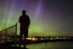 Wade Kitner looks at the northern lights as he fishes in Ventura, Iowa, on Tuesday, June 23, 2015.  A fireworks show that has nothing to do with the Fourth of July and everything to do with the cosmos is poised to be visible across the northern United States and Europe just in time for the Halloween weekend, Saturday, Oct. 30, 2021. (Arian Schuessler, The Globe Gazette via AP, File)