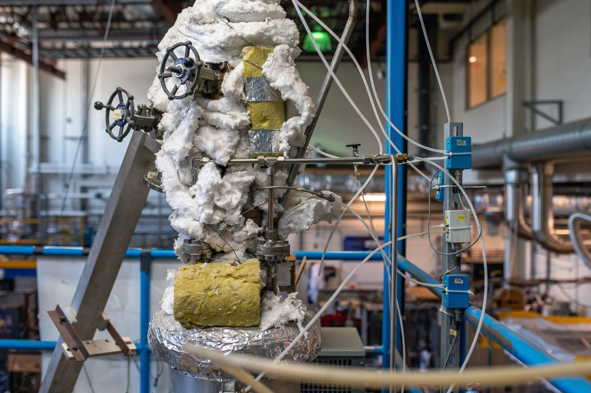 Controls, valves, and cables surround a point-source carbon capture technology used to separate and sequester CO2.