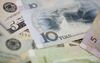 Yuan bank notes and U.S. dollar bills