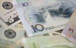Yuan bank notes and U.S. dollar bills