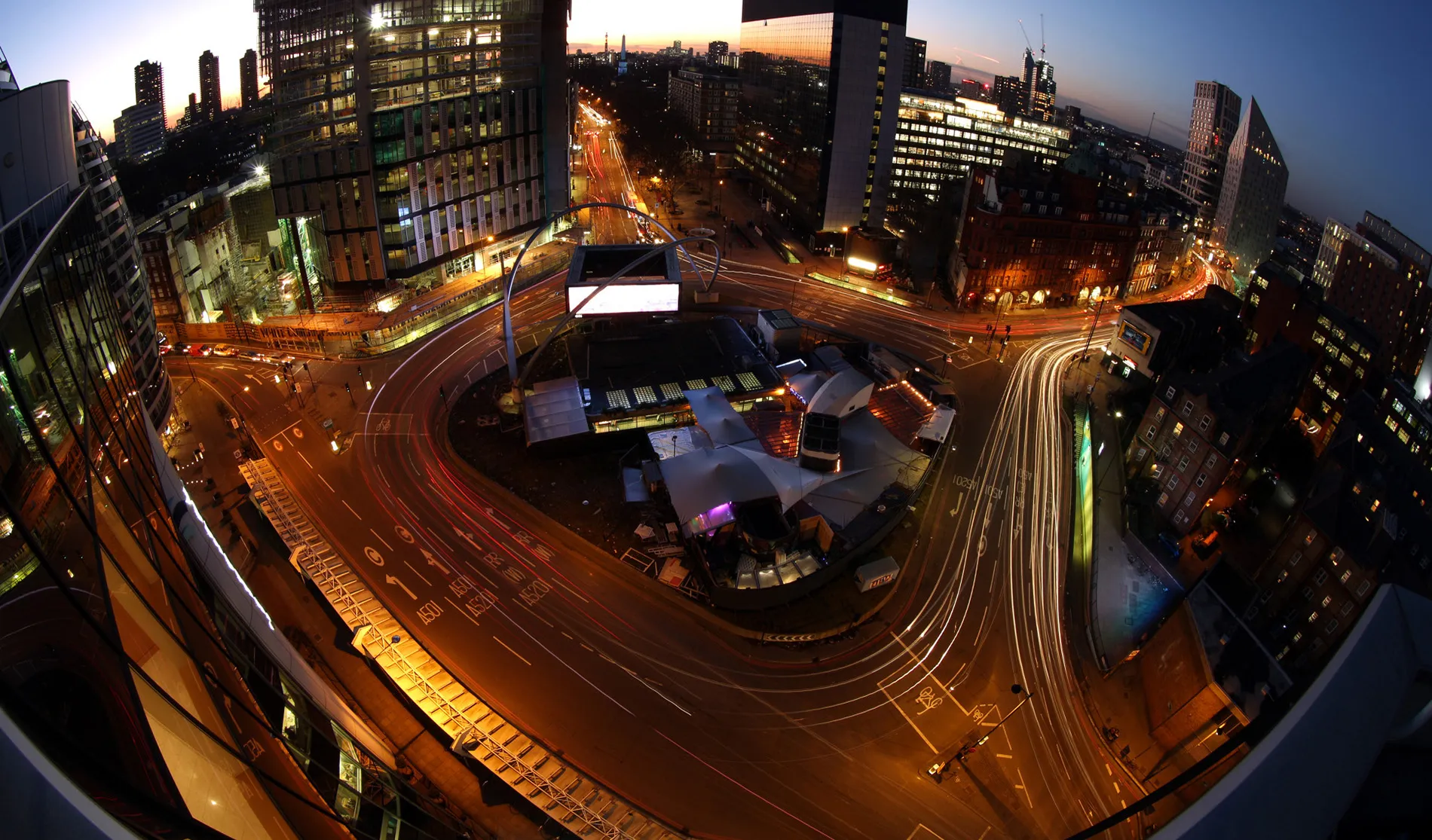 Light trails made by traffic passing around the Old Street roundabout, also referred to as 'Silicon Roundabout,' in the area known as 'Tech City' at dusk in London.
