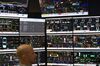 A control room operator watches a wall of screens covered in diagrams and figures, monitoring processing facilities and pipelines at ConocoPhillips’ Alpine oil field on the North Slope of Alaska.