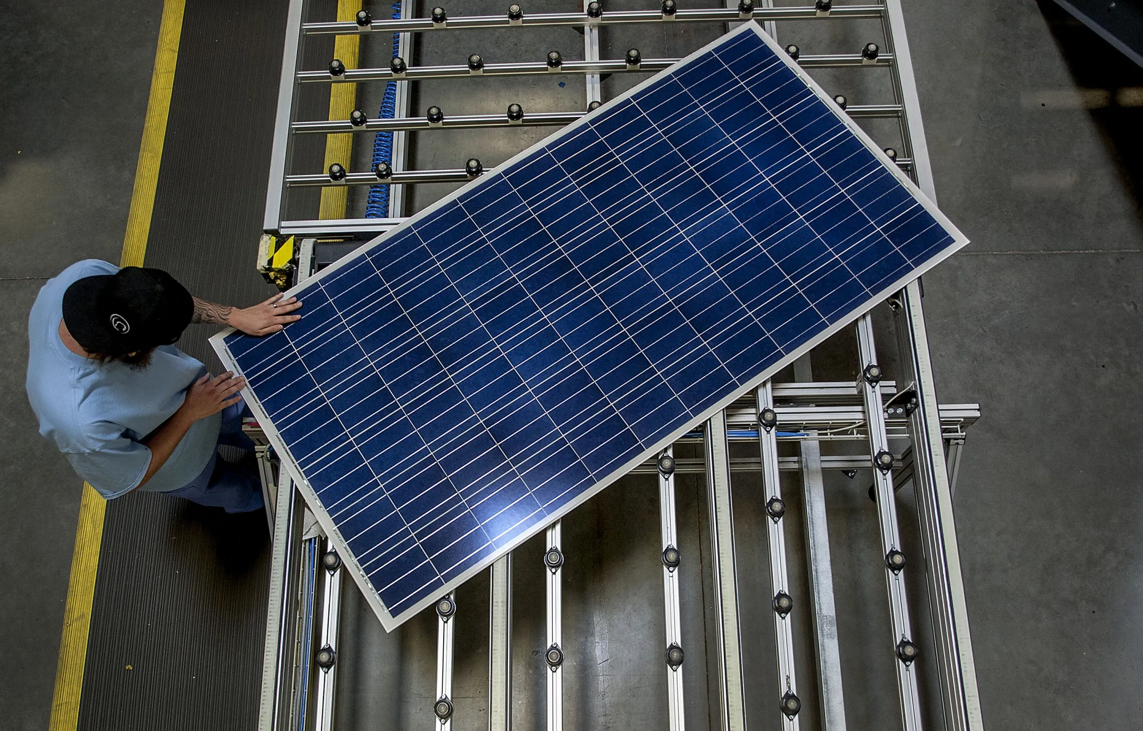 An employee inspects a solar panel on the production line&nbsp;in Goodyear, Arizona.