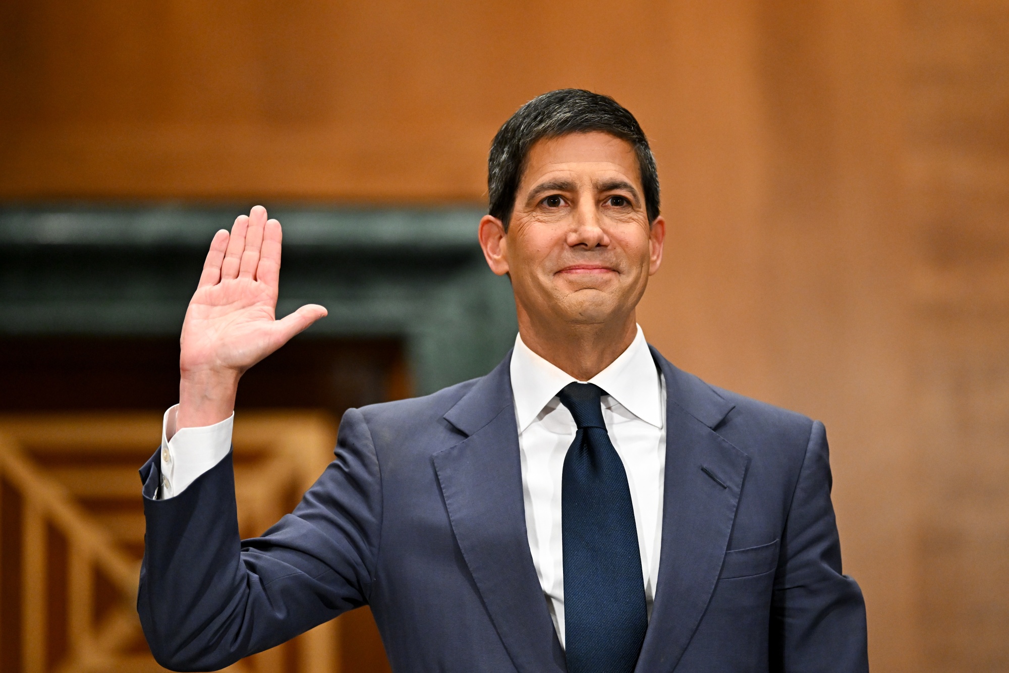Kevin Warsh, chairman of the US Federal Reserve nominee for US President Donald Trump, is sworn in during a Senate Banking, Housing, and Urban Affairs Committee confirmation hearing in Washington, DC, US, on Tuesday, April 21, 2026. Warsh's testimony highlights the fine line he must walk during the hearing between President Donald Trump's demands for lower rates and reassuring investors that he will defend the Fed's autonomy in rate-setting.