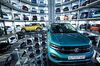 New Volkswagen AG (VW) T-Roc, left, and T-Cross SUVs are guided into storage bays inside one of the automaker's Autostadt delivery towers at the VW headquarters in Wolfsburg, Germany, on Tuesday, Dec. 4, 2018.