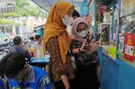 Customers scan a QR code at a food stall in Jakarta.