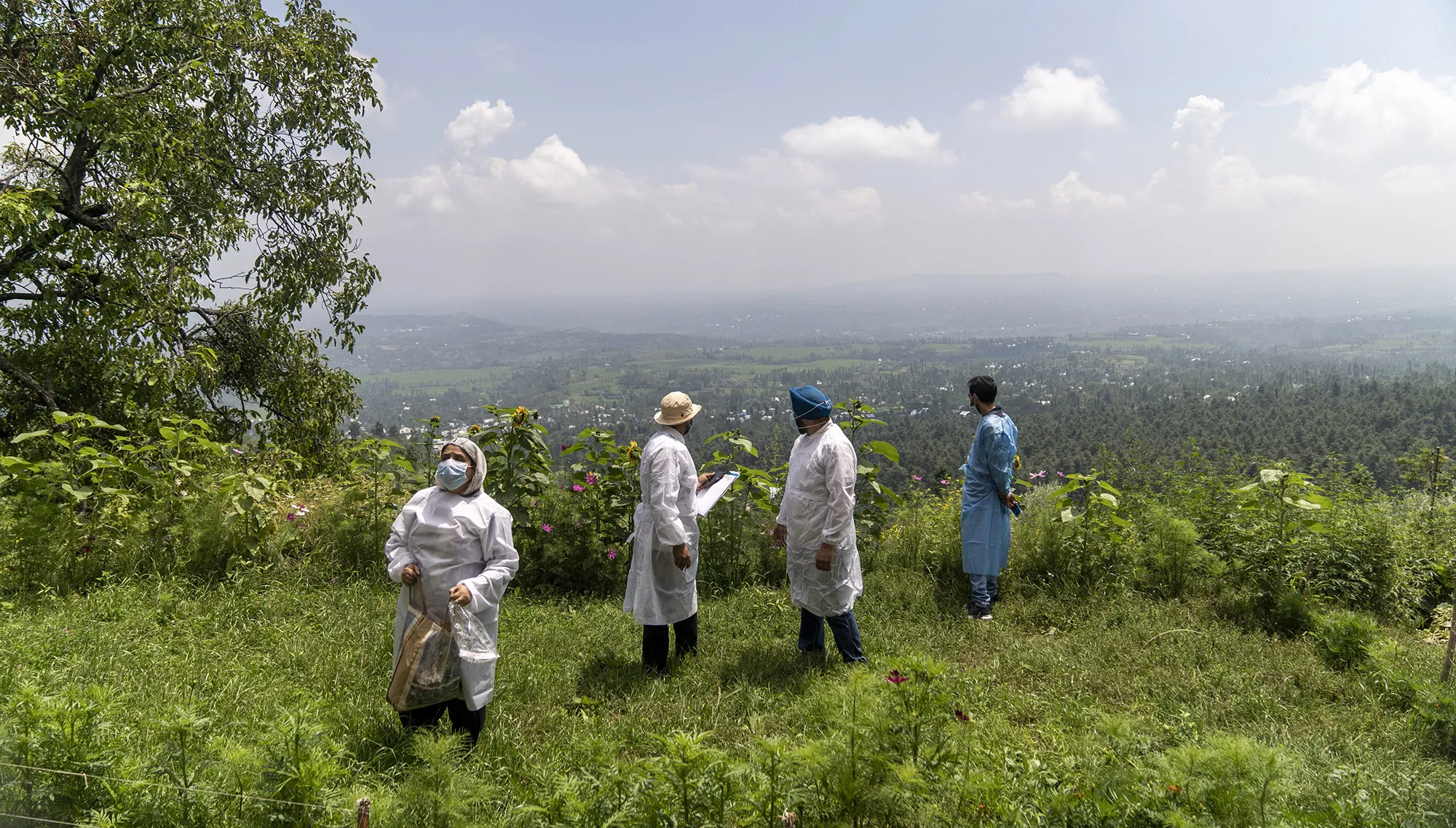 A 'door-to-door' Covid-19 vaccination team surveys the area&nbsp;at a village in the Budgam district of Jammu and Kashmir, India.