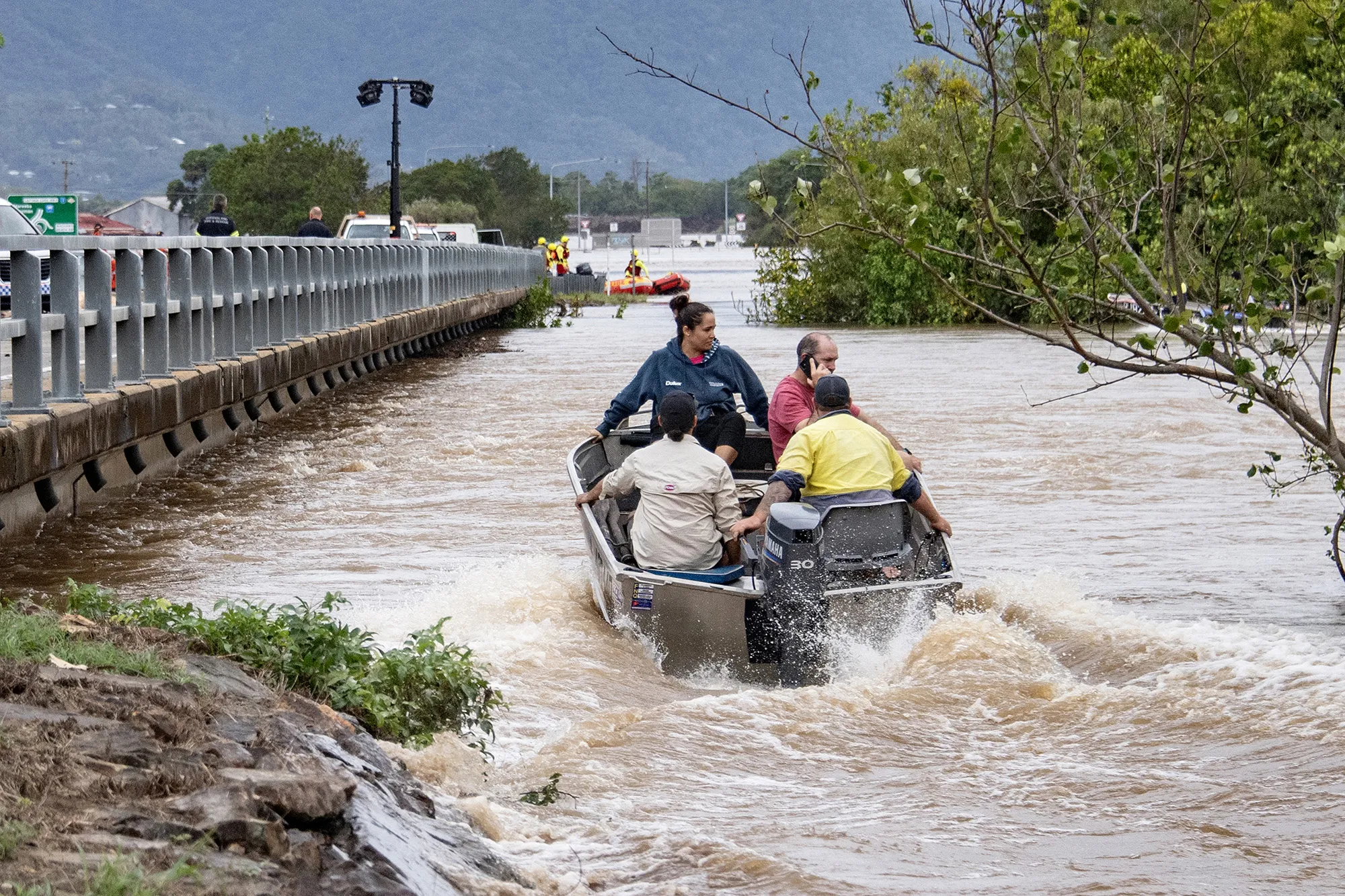 Residents cross floodwaters by boat in Cairns, Australia on Dec. 18.
