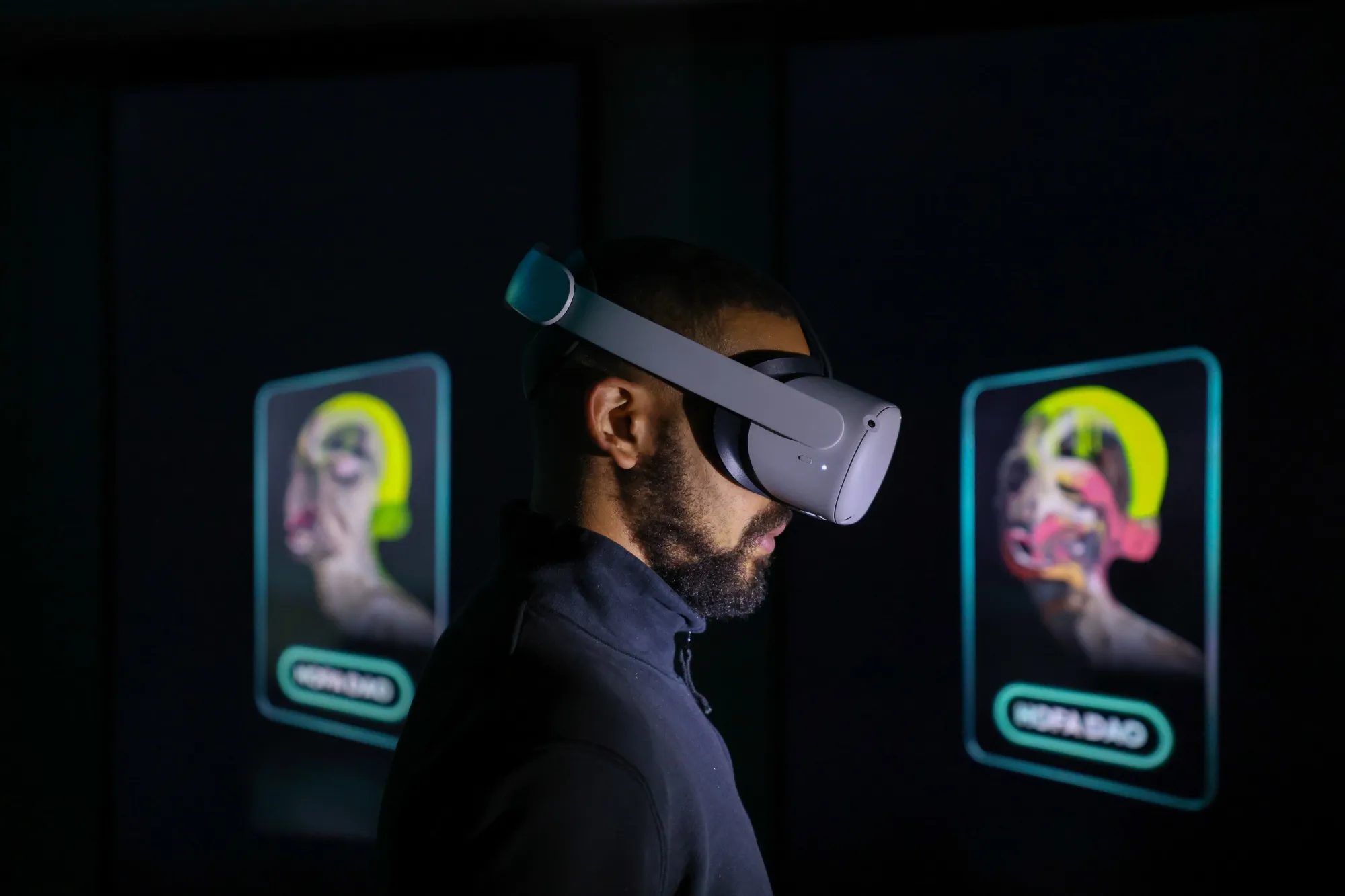 A user wears an Oculus Quest VR headset to view a virtual art gallery.