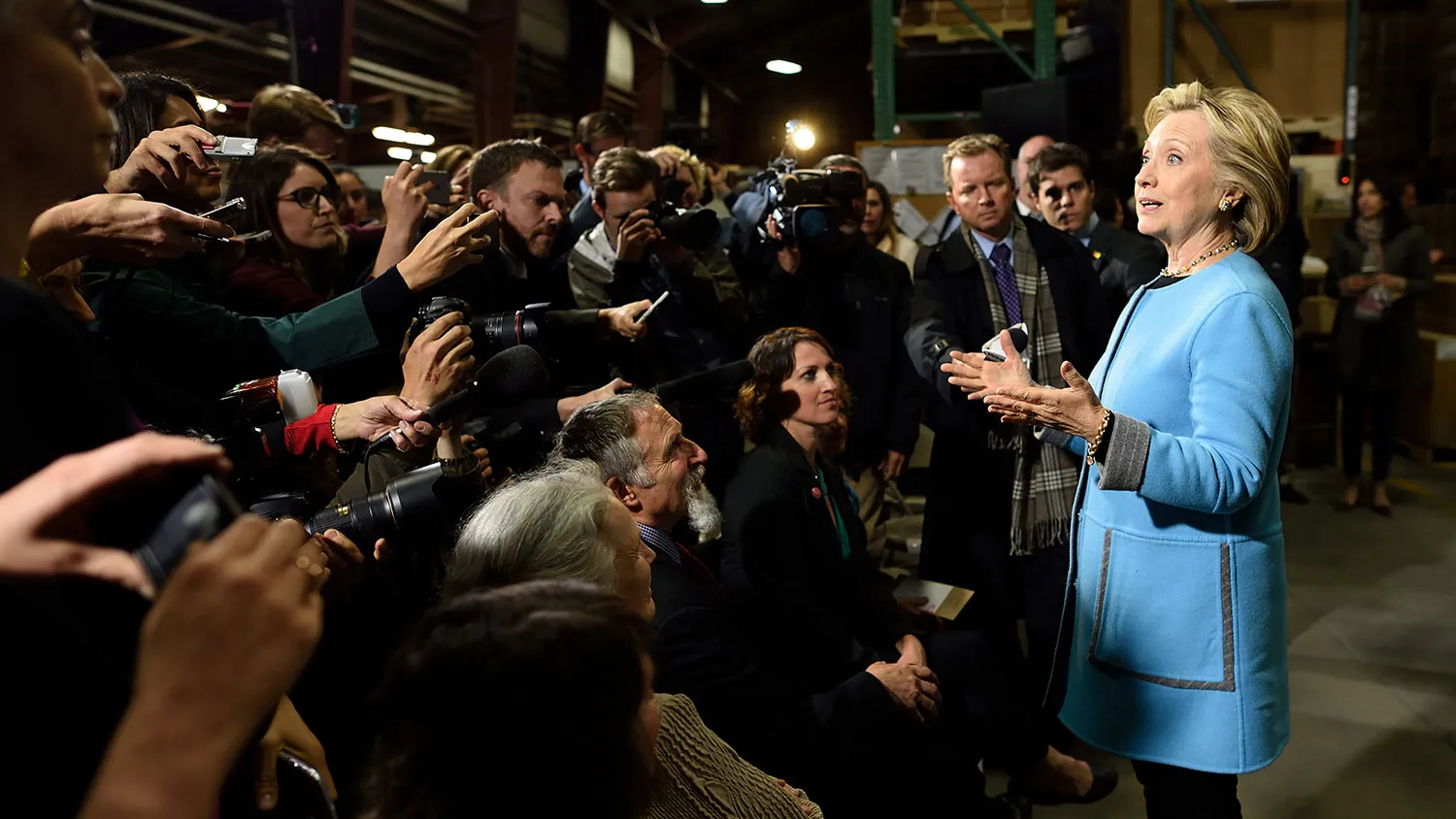 Hillary Clinton answers questions from reporters after participating in a round table discussion with Whitney Brothers management and employees April 20, 2015 in Keene, New Hampshire.
