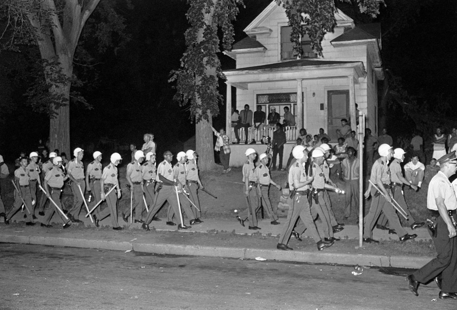 Police in riot gear march down Plymouth Avenue during riots in North Minneapolis on July 21, 1967.