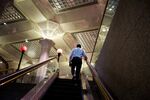 A commuter exits the Wall Street subway station near the New York Stock Exchange. 