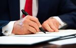 U.S. President Donald Trump signs an executive order&nbsp;on Monday, June 24.