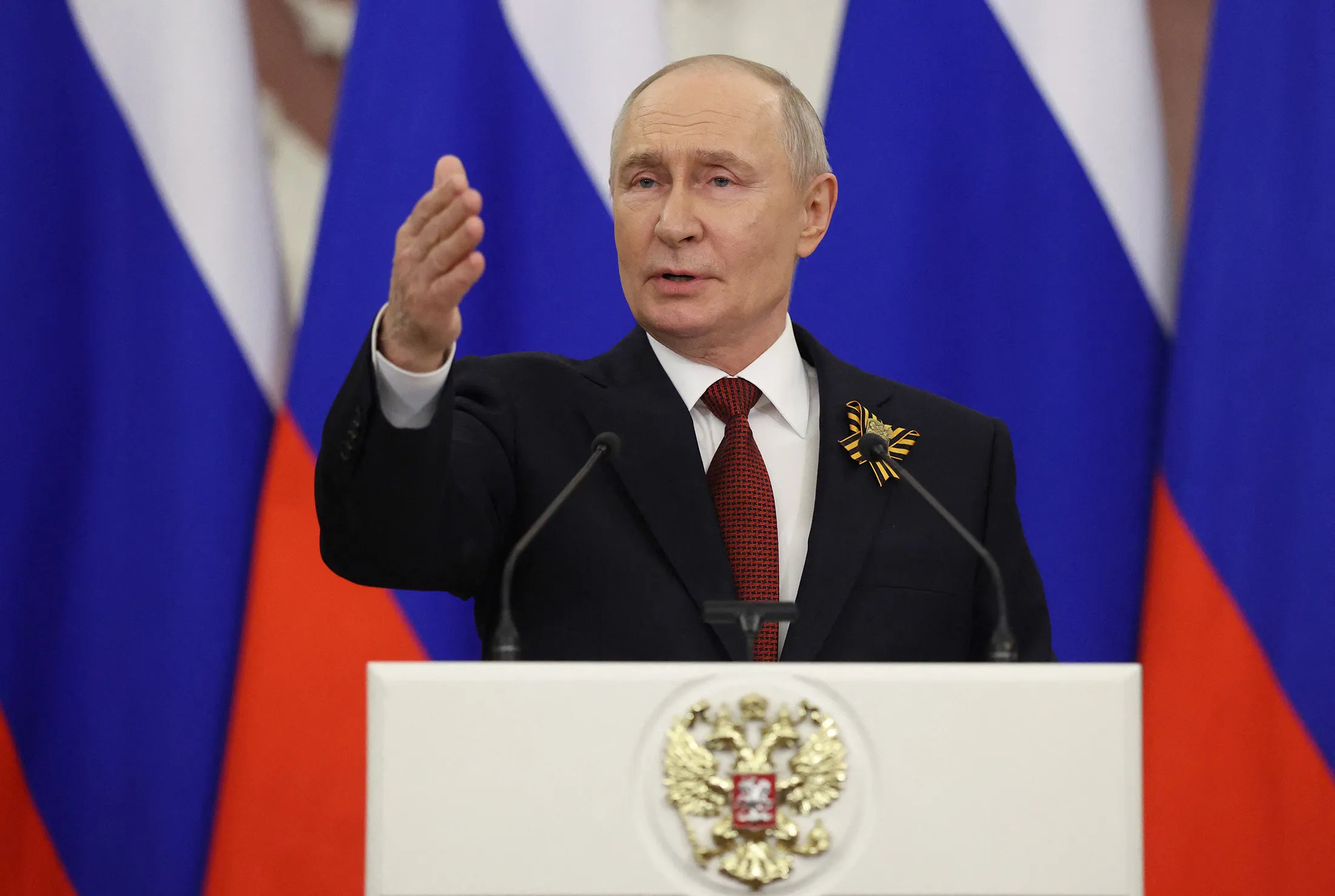 Russian President Vladimir Putin talks to the media following his meetings with foreign delegations at the Kremlin in Moscow on May 9.